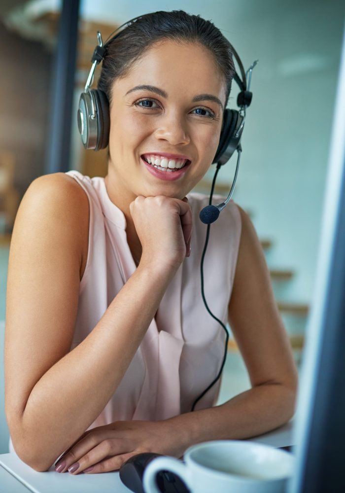 Here to help you with your queries. Shot of a young woman working in a call center